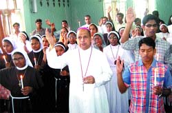 Bishop Anil Couto along with others pray for peace at a church in Jalandhar cantonment on Wednesday