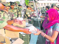 Troops distribute packed food among stranded passengers at Jammu railway station