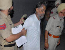 Cops take away Gurjeet Singh Sidhu in Bathinda on Thursday.