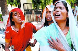 Grieving relatives of the pavement dwellers who were crushed by a car being driven by a drunk man in Kanhaiya Nagar 