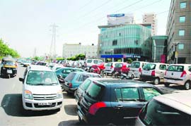Cars and other vehicles parked on a busy road and the footpath in gross violation of the rules in the DLF area in Gurgaon