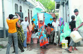 Residents of Shahabad Mohammodpur near Dwarka collect water from a tanker in New Delhi on Friday.