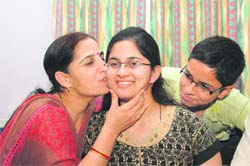 Nikita Varshaney gets a kiss from her mother. 