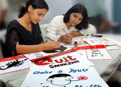 Staff members of the Vivekanand College for Girls preparing placards against the use of tobacco on the World No Tobacco Day