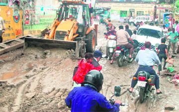 The mudslide at Laltaura bridge being removed by earthmovers