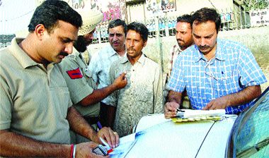 Health Department officials challan people, who were caught smoking at public places, in Amritsar on Saturday.