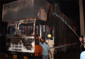 Firefighters try to put out the fire in a truck on National Highway No-8 near Sikohpur Chowk, Gurgaon