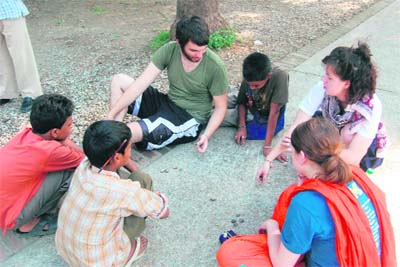 Foreigners join children at a game of marbles at Gandhi Park in Dehradun on Sunday.T