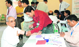 A patient gets checked-up at a health camp organised by Apollo Clinic in Dehradun on Sunday.