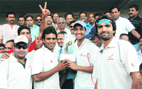 The Air India team with the 27th Uttaranchal Gold Cup cricket trophy in Dehradun on Sunday.