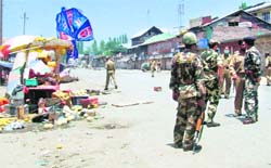 Security personnel inspect the spot where a Lok Janshakti Party leader was attacked at Sopore on Sunday. 