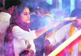 A devotee offers prayers at Mata Kheer Bhawani Temple in Jammu on Sunday.