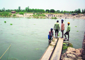 Villagers stand near the collapsed bridge at Burj in Anandpur Sahib, on Sunday.