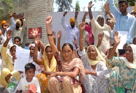 Labourers of Poohla village protest alleged high-handedness of the NREGS authorities outside the DCs residence in Bathinda