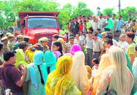 Residents of Saheri village blocking traffic on the Dharamsala-Una highway on Monday against improper action by the police in a murder case