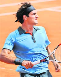 Roger Federer reacts after winning his match against Tommy Haas at Roland Garros