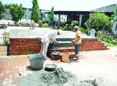 Workers construct a platform for the funeral of Sant Ramanand at Ballan village.