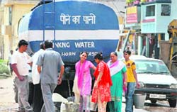 A tanker of the Jammu Municipal Corporation supplies water in Nai Basti.
