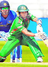Raqibul Hasan of Bangladesh (R) plays a stroke as Sri Lankan wicketkeeper Kumar Sangakkara  watches during the Twenty 20 World Cup warm up game at Trent Bridge, in Nottingham, on Tuesday.