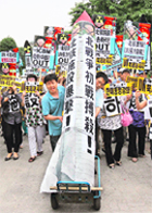 Conservative protesters march with a mock North Korean missile during an anti-North Korea rally in Seoul on Tuesday.