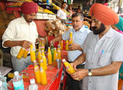 Health department officials confiscating spurious soft drink bottles from a shop near Bathinda bus stand on Wednesday.