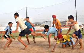 Kabaddi players playing a game during the 15-day summer camp being organised at the Sports Stadium in Bathinda on Wednesday.