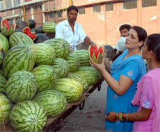Women checking out a watermelon before making a purchase in Bathinda on a hot Wednesday afternoon.