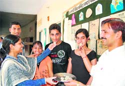 Saraswati Shishu Vidya Mandirs top three Bhagyashree Mudgal (in black), Rajat Sharma and Babita Zhingran (in orange) being offered sweets by school officials