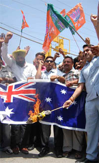BJP activists burn an Australian flag in protest aganist the racial attacks on Indians living in the Kangaroo nation in Jalandhar on Wednesday.