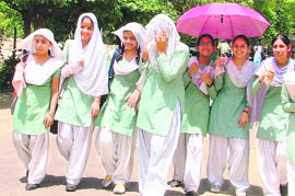 Schoolgirls try to fight scorching sun in Ludhiana on Wednesday.