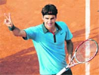 Roger Federer celebrates after his victory over Gael Manfils at Roland Garros