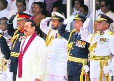 Sri Lankan President Mahinda Rajapaksa (C) stands to attention with commanders of the Sri Lankan military during the National Victory Ceremony in Colombo on Wednesday.