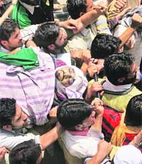 Mourners carry the body of Nissar Ahmad for funeral in Srinagar on Thursday. He died in hospital on Thursday after being hit by a gas canister earlier this week.