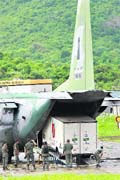 Ground crew unloads a refrigerated truck carrying debris of Air France jet from a Brazilian Air Force C-105 at Fernando de Noronha Island's airport o