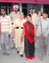 Janki Devi, her husband Vijay Pal (extreme left) and her brother Ram Kewal (extreme right) in the police custody at the Mani Majra police station