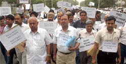 Members of the Chamber of India Udyog Vihar take out a silent protest march against the HSIIDC in Gurgaon