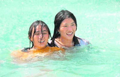 Girls take a dip in a swimming pool to beat the sweltering heat in Dehradun.