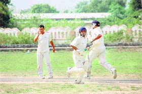 Batsmen cross over for a run in the final of Kendriya Karamchari cricket tournament in Dehradun