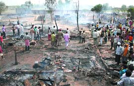 Fire brigade men extinguish fire at Sheikhupura in Kapurthala on Friday. Fifty shanties were reduced to ashes.