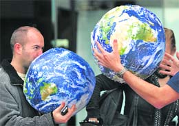 A man prepares inflatable globes for World Environment Day celebrations in Central Sydney on Friday. 