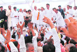 Congress workers try to reach out to Chief Minister Bhupinder Singh Hooda to submit their personal requests after a thanksgiving rally in Chandigarh on Saturday.