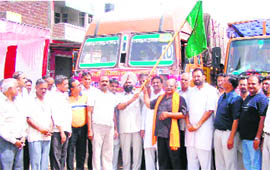 Executive magistrate Karamjit Singh flags off trucks carrying ration at Ahmedgarh on Saturday.