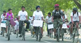 Participants at the Climate Bicycle and Bus Ride rally organised by Delhi Cycling Club from Pragati Maidan, to raise awareness on climate change and promote bicycle & public transport to reduce carbon footprint in order to save environment in New Delhi on Sunday.