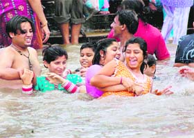 Devotees take a dip in Ganga waters on the occasion of Poornima in Haridwar