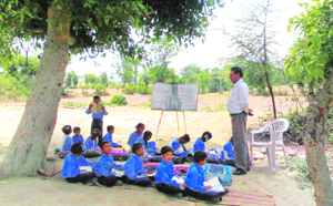 Students of Government Middle School at Doog Bakshian attend classes in the open due to non-availability of classrooms.