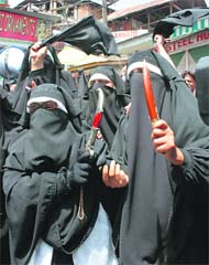 Activists of the Dukhtaran-e-Millat march towards Eidgah in Srinagar on Sunday during a protest rally against the mysterious death of two women in Shopian.