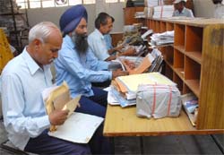 Staff at work in the Post Office located in Dhobi Bazaar, Bathinda,