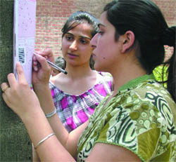 Girls give final touch to their admission forms at Delhi University on Monday.