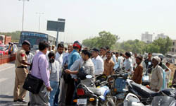 People gather at the accident site in Gurgaon.