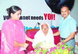 IG V. Kamaraja felicitates 102-year-old Bhagwanti Khurana during a function at the PGIMS in Rohtak.